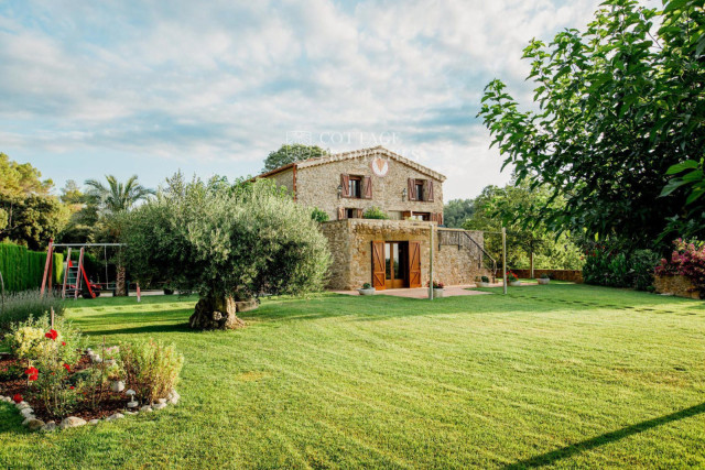 An example of a beautiful masía built from stone with extensive grounds, located in Lladó, Girona, Catalonia.